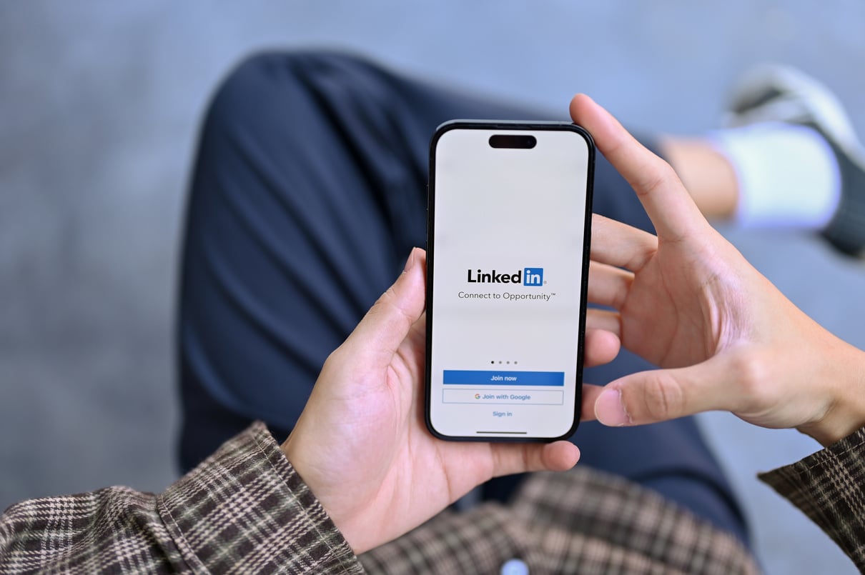 Top view of a man in casual clothes using LinkedIn website on hi